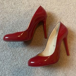 Red patent round toe Louboutin pumps